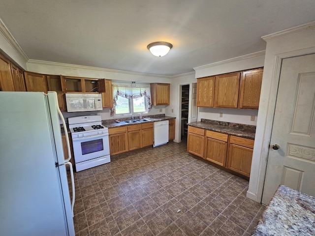 kitchen featuring white appliances, crown molding, a sink, brown cabinetry, and dark countertops