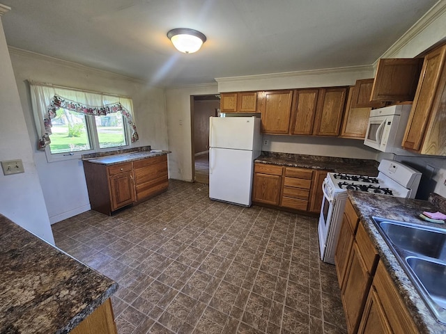 kitchen with white appliances, a sink, brick patterned floors, brown cabinets, and baseboards