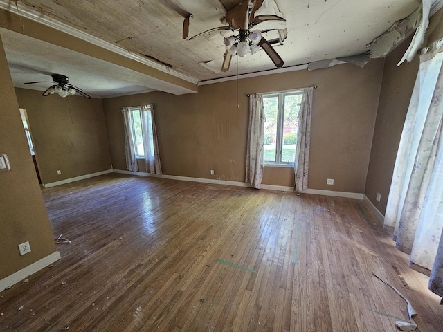 spare room featuring a ceiling fan, hardwood / wood-style floors, and baseboards