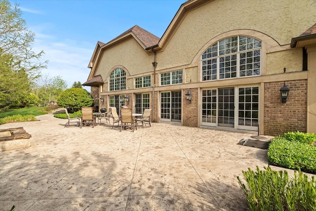 137 Singletree Rd, Orland Park, IL 60467 - rear view of property with stucco siding and a patio
