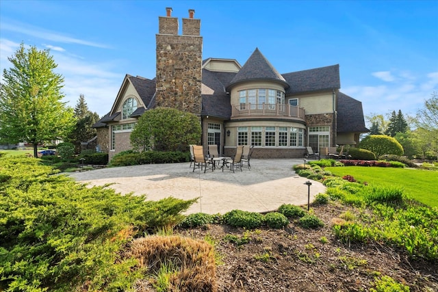 137 Singletree Rd, Orland Park, IL 60467 - rear view of property with a balcony, a patio, a chimney, and stucco siding