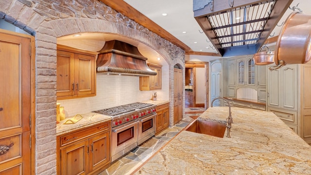 137 Singletree Rd, Orland Park, IL 60467 - kitchen featuring a sink, range with two ovens, custom range hood, tasteful backsplash, and light stone counters