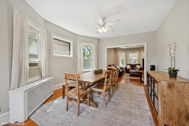 6329 N Hermitage Ave, Chicago, IL 60660 - dining area featuring radiator, wood finished floors, a ceiling fan, and baseboards