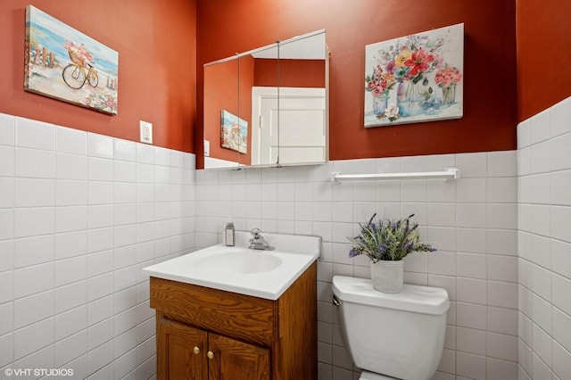 6329 N Hermitage Ave, Chicago, IL 60660 - half bath with tile walls, toilet, vanity, and wainscoting