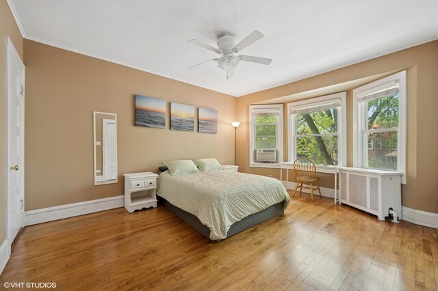 6329 N Hermitage Ave, Chicago, IL 60660 - bedroom featuring radiator heating unit, wood-type flooring, baseboards, and a ceiling fan