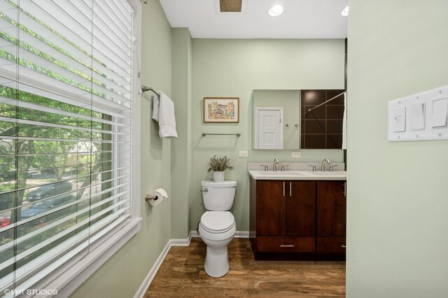 6329 N Hermitage Ave, Chicago, IL 60660 - bathroom with wood finished floors, toilet, baseboards, and double vanity