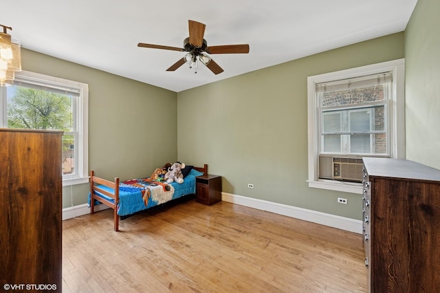 6329 N Hermitage Ave, Chicago, IL 60660 - bedroom with light wood finished floors, baseboards, ceiling fan, and cooling unit