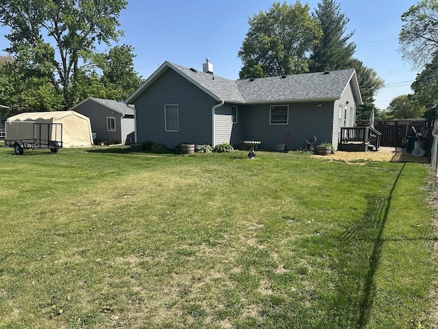 210 W S St, Sheffield, IL 61361 - back of house featuring a lawn, roof with shingles, and a wooden deck
