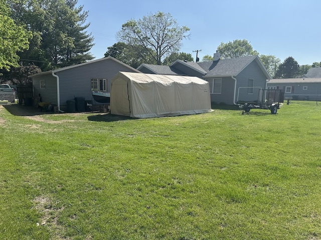 210 W S St, Sheffield, IL 61361 - view of green lawn with an outdoor structure and a storage unit