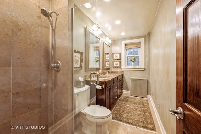 bathroom featuring toilet, tiled shower, vanity, baseboards, and radiator heating unit