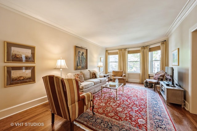 living area featuring crown molding, baseboards, and wood finished floors