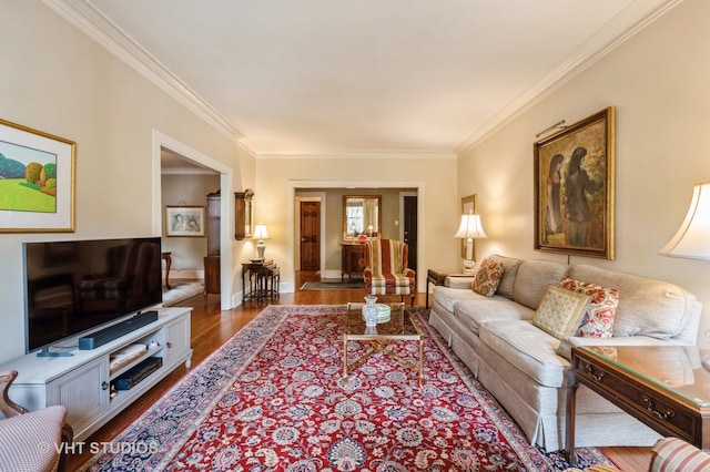 living area with wood finished floors, crown molding, and baseboards