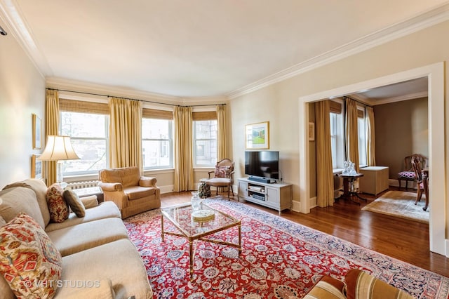 living room featuring ornamental molding, wood finished floors, and baseboards