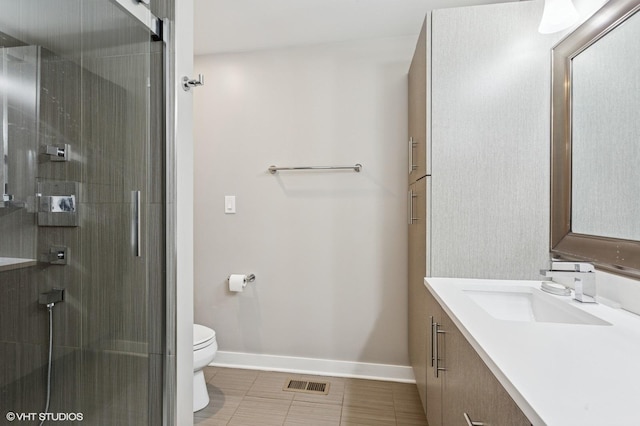 2751 Prairie Ave, Evanston, IL 60201 - bathroom with toilet, vanity, baseboards, tile patterned floors, and a shower with shower door