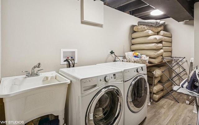 2751 Prairie Ave, Evanston, IL 60201 - laundry room with light wood finished floors, washing machine and clothes dryer, and a sink