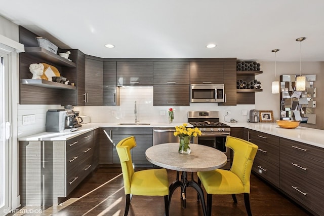 2751 Prairie Ave, Evanston, IL 60201 - kitchen featuring open shelves, stainless steel appliances, a sink, dark brown cabinets, and light countertops