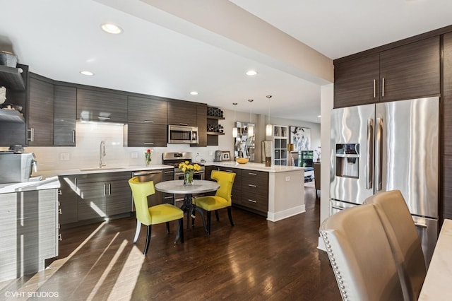 2751 Prairie Ave, Evanston, IL 60201 - kitchen featuring open shelves, a sink, stainless steel appliances, a peninsula, and light countertops