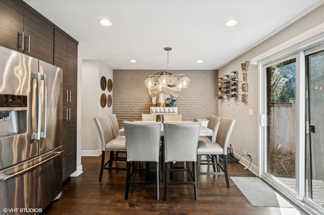 2751 Prairie Ave, Evanston, IL 60201 - dining room with dark wood-type flooring, a chandelier, baseboards, recessed lighting, and brick wall