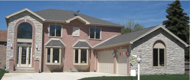 view of front facade with concrete driveway and a garage