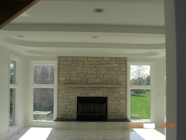 unfurnished living room featuring a stone fireplace