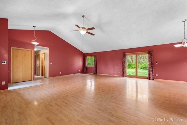 118 Centralia Pl, Poplar Grove, IL 61065 - unfurnished living room with wood finished floors, a ceiling fan, vaulted ceiling, and baseboards