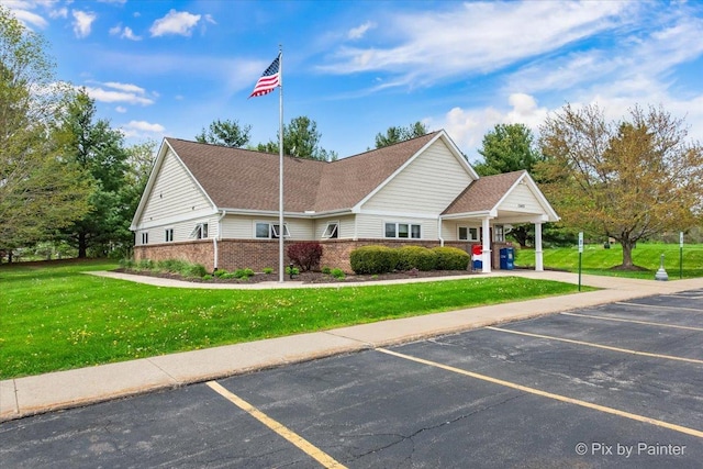 118 Centralia Pl, Poplar Grove, IL 61065 - view of front facade featuring a front lawn, uncovered parking, and brick siding