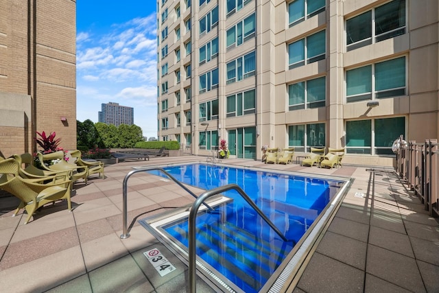 community pool with a patio area