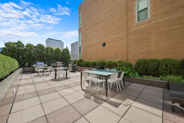 view of patio / terrace featuring outdoor dining space and a city view