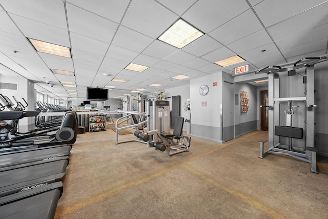 workout area featuring a drop ceiling and baseboards