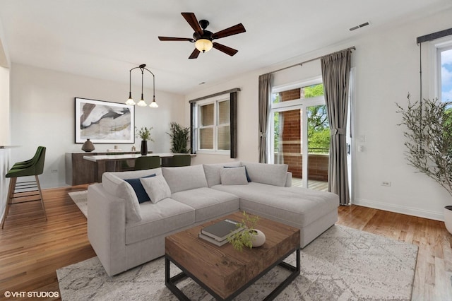 4727 N Clark St Unit 2S, Chicago, IL 60640 - living area with a ceiling fan, plenty of natural light, and light wood-style flooring