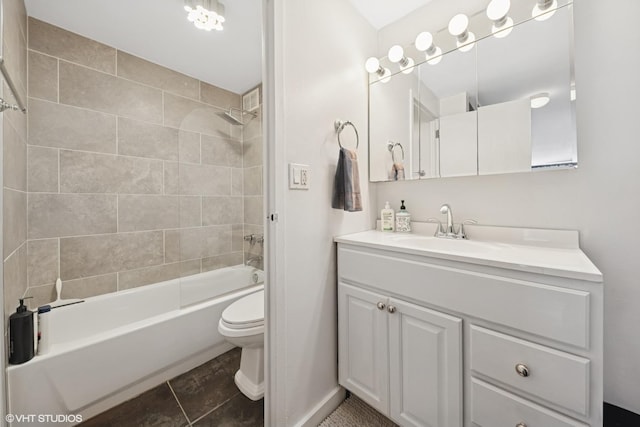 bathroom with vanity, toilet, washtub / shower combination, and baseboards