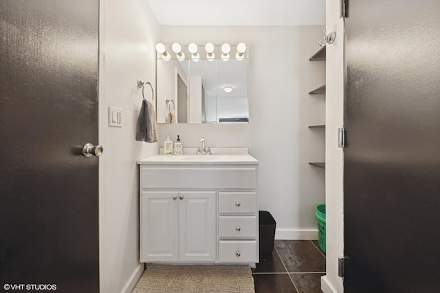 bathroom featuring vanity, tile patterned flooring, and baseboards