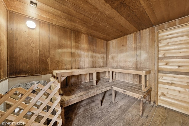 sauna with wood ceiling, wood walls, and hardwood / wood-style flooring
