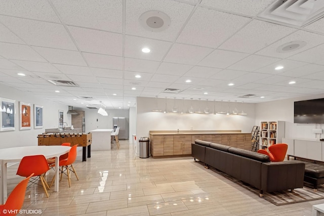 common area with a paneled ceiling and recessed lighting