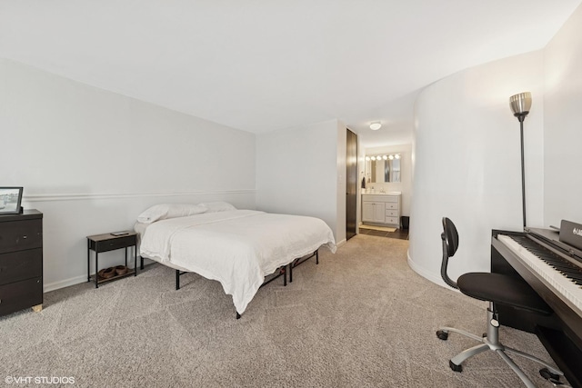 carpeted bedroom featuring a desk, baseboards, and ensuite bathroom