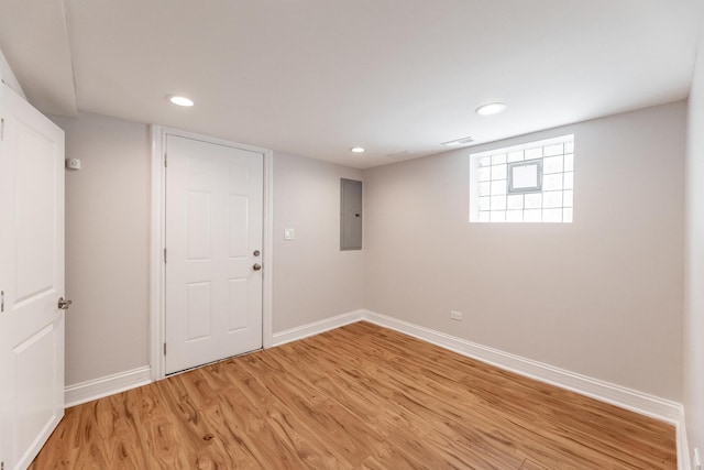 11311 S Stewart Ave, Chicago, IL 60628 - below grade area with baseboards, light wood-style floors, electric panel, and recessed lighting