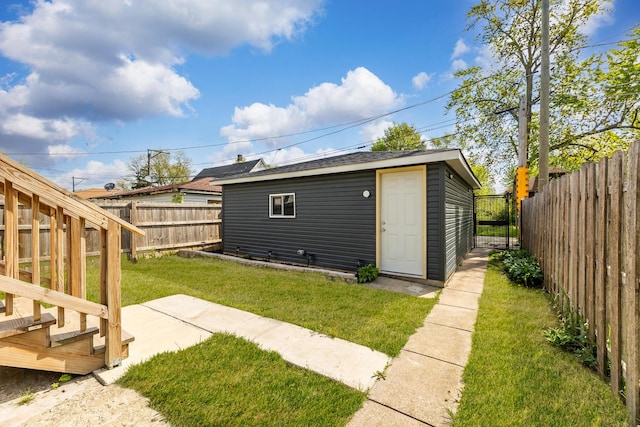 11311 S Stewart Ave, Chicago, IL 60628 - rear view of house with a gate and an outbuilding
