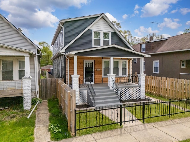 11311 S Stewart Ave, Chicago, IL 60628 - view of front of house with covered porch, a fenced front yard, and stairway