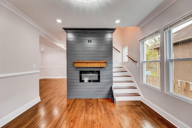 11311 S Stewart Ave, Chicago, IL 60628 - stairs with ornamental molding, baseboards, a large fireplace, wood finished floors, and recessed lighting