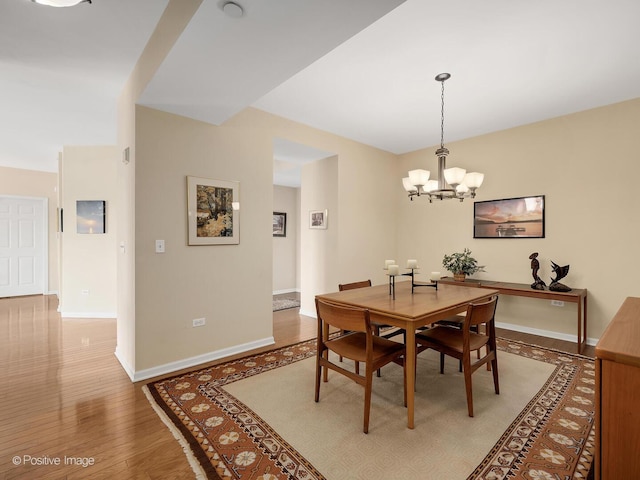 131 W Adelaide St Unit 308, Elmhurst, IL 60126 - dining area with a chandelier, baseboards, and wood finished floors