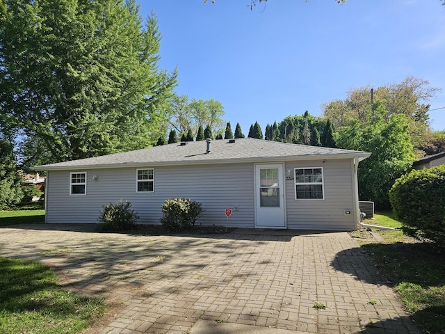 rear view of house featuring a patio and central AC unit