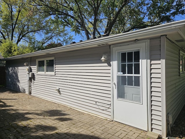 view of side of property with a patio
