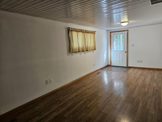 entrance foyer with dark wood-style floors and baseboards