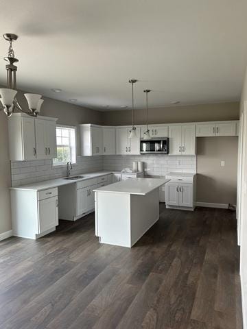 1415 Warwick, Savoy, IL 61874 - kitchen featuring stainless steel microwave, a sink, tasteful backsplash, and white cabinetry