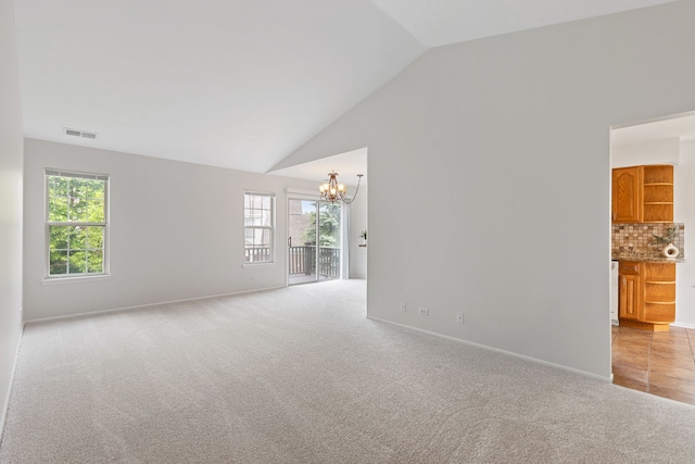 283 E Fabish Dr, Buffalo Grove, IL 60089 - spare room with a chandelier, light colored carpet, healthy amount of natural light, baseboards, and high vaulted ceiling