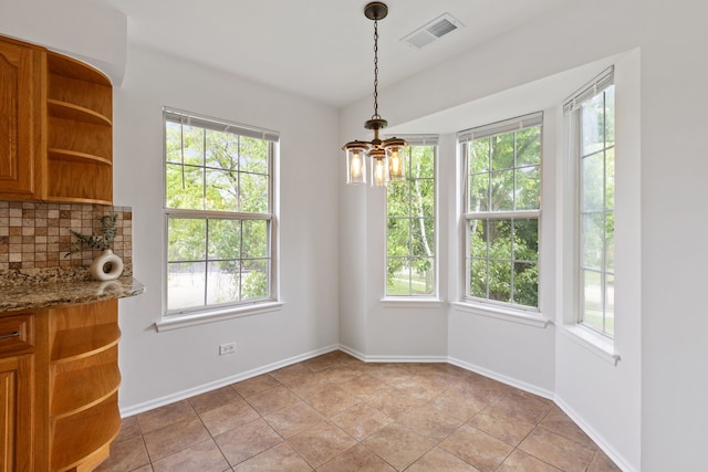 283 E Fabish Dr, Buffalo Grove, IL 60089 - unfurnished dining area with plenty of natural light, baseboards, and a chandelier