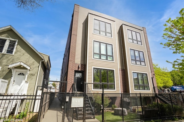 view of front of house featuring fence