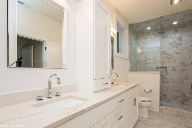 full bathroom featuring marble look tiles, toilet, tiled shower, and double vanity