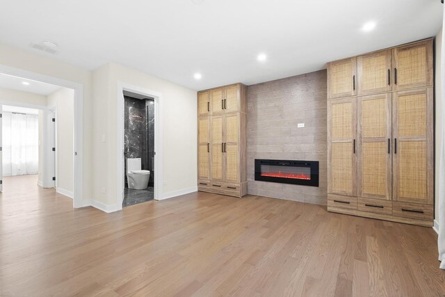 unfurnished living room featuring a fireplace, light wood-type flooring, recessed lighting, and baseboards