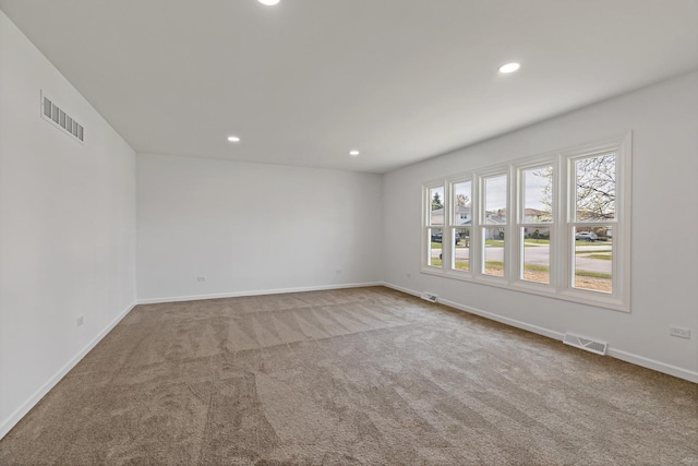 spare room with carpet flooring, recessed lighting, and baseboards
